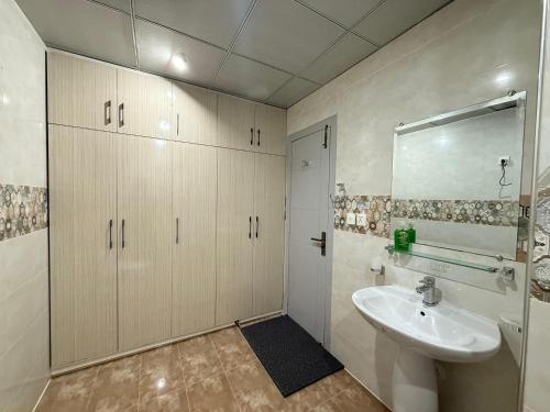 a bathroom with a sink and a mirror at 2 BHK Stayloom 218 in Rawalpindi