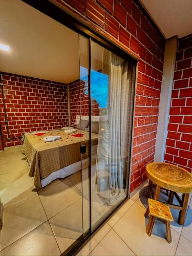 a room with a bed and a brick wall at Pousada Martins Turismo in Carolina