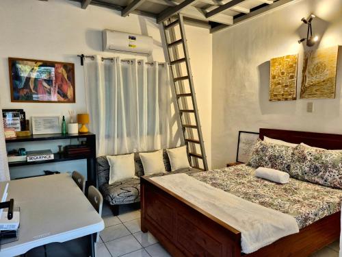 a bedroom with a bed and a desk in a room at Sotera and Paz Forestville in Silang