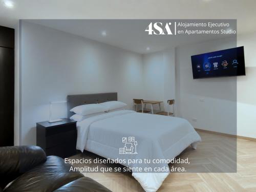 a bedroom with a white bed and a tv at 4StudioAparts RC 04 in Cajamarca