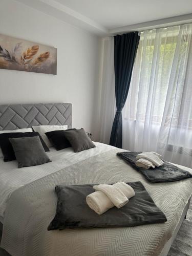 a bedroom with a bed with two towels on it at Monteluce Apartment Vlašić in Šišava