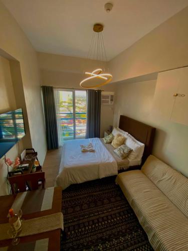 a bedroom with a bed and a couch at The Loop North Tower in Cagayan de Oro