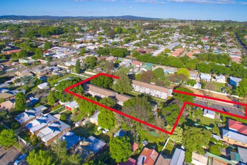 an aerial view of a suburb with a red rectangle at Summer East Apartments in Orange