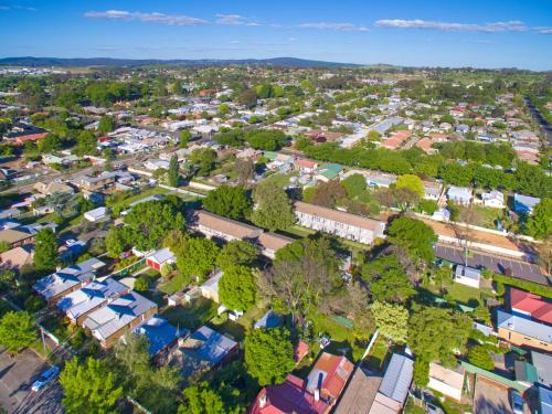 an overhead view of a city with houses and trees at Summer East Apartments in Orange