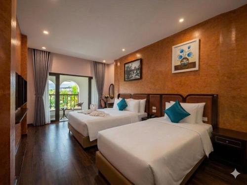 a hotel room with two beds and a television at Valoria Premium Hanoi Hotel and Travel in Hanoi