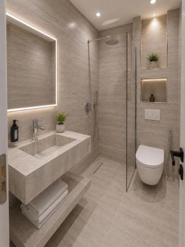 a bathroom with a sink and a toilet at Prima Garden Residence in Durrës