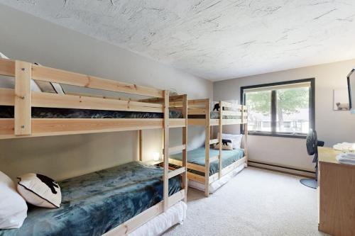 two bunk beds in a room with a window at Cozy Condo In The Woods in Lincoln
