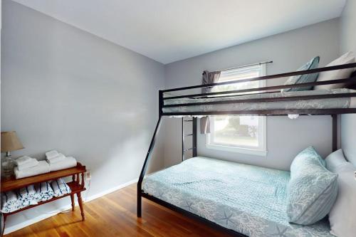 a bedroom with a bunk bed and a window at Gloucester Getaway in Gloucester