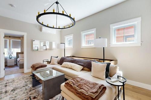 a living room with a couch and a chandelier at Mountain Sunset Villa in Waterville Valley