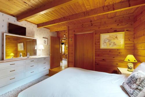 a bedroom with a large bed and a bathroom at Saco River Hideaway in Bartlett