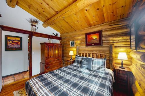 a bedroom with a bed in a log cabin at Bucks House in Jackson