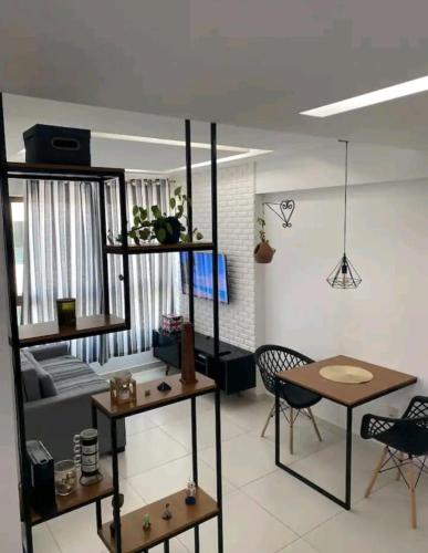 a living room with a couch and a table at Apt Completo com Vista para o Mar, Ar Condicionado e Café da Manhã Opcional in Recife