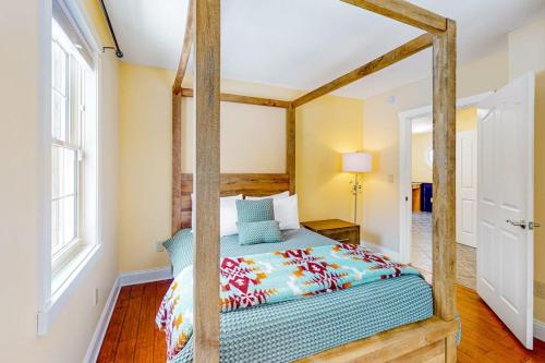 a bedroom with a canopy bed in a room at RiverHouse in Ogunquit