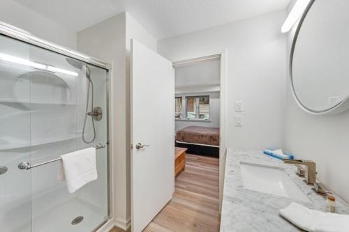 a bathroom with a shower and a sink and a mirror at Windriver Retreat in Teton Village