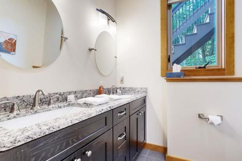 a bathroom with a sink and a mirror and a window at Ferncrest Mountain House in Conway