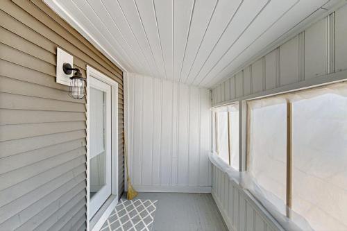 an empty room with a window and a door at Eagle's Nest in Bridgton