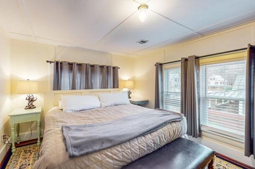 a bedroom with a large bed and a window at Kendall Brooke in North Conway