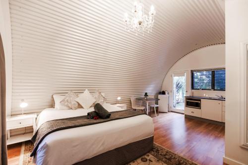 a bedroom with a large bed in a room at Romantic Couples Retreat in Mount Tamborine