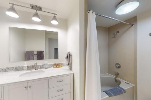a bathroom with a shower and a sink and a tub at Tensleep B11 in Teton Village