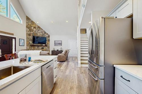 a kitchen with a refrigerator and a living room at Cranmore Road 7 in North Conway
