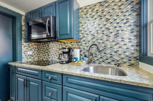 a kitchen with blue cabinets and a sink at Wishing Wells in Wells