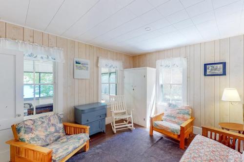 a living room with a couch and a chair at Garden Island's Birch in Charlotte