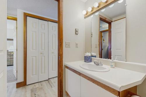 a white bathroom with a sink and a mirror at Slopeside 4001 in Jay
