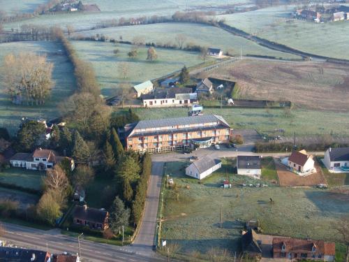 an aerial view of a village with a large building at Hotel Le Saint Aubin in Gournay-en-Bray