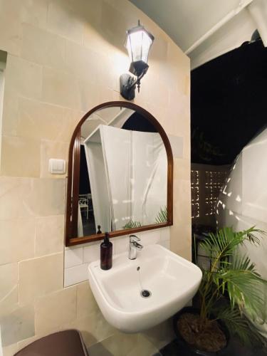 a bathroom with a sink and a mirror at The Heaven Royal Glamp in Bedakah