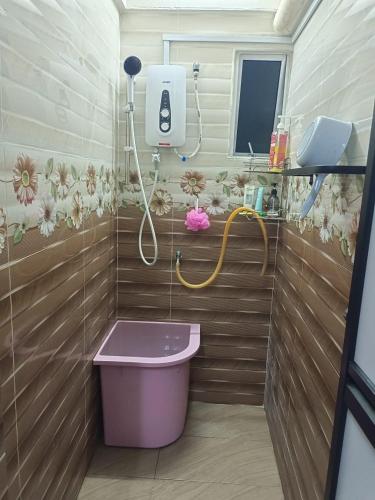 a bathroom with a purple tub and a shower at D'Nas Homestay in Rawang