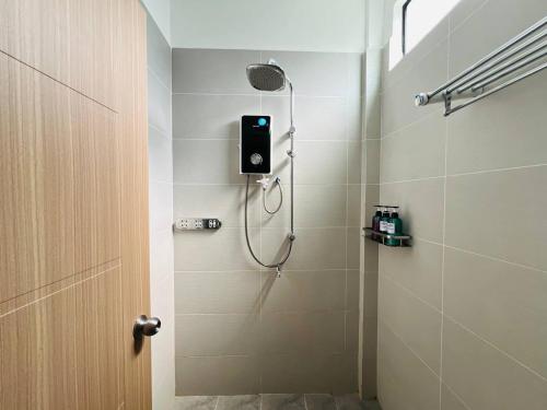 a bathroom with a shower with a shower head at Sandy Clay Bungalows in Sihanoukville