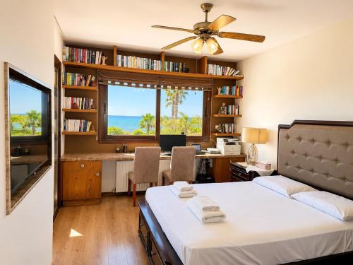 a bedroom with a bed and a desk with a computer at Emerald Seafront Residence in Ayia Napa