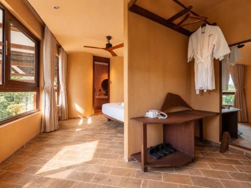 a room with a bedroom with a bed and a table at Camly the Boutique in Da Lat