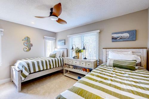 a bedroom with two beds and a ceiling fan at Barefoot Bliss in Kennebunk
