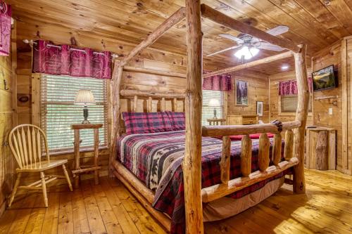 a bedroom with a bed in a log cabin at Naughty Pines in Pigeon Forge