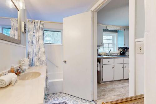 a white bathroom with a sink and a counter at Meet Me At Sea in York