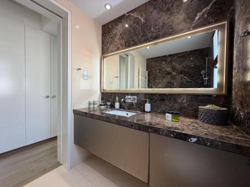 a bathroom with a sink and a mirror at Emerald Seafront Residence in Ayia Napa