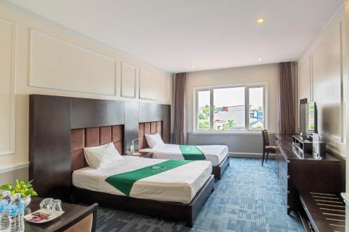 a hotel room with two beds and a television at MAY PLAZA HOTEL in Thái Nguyên
