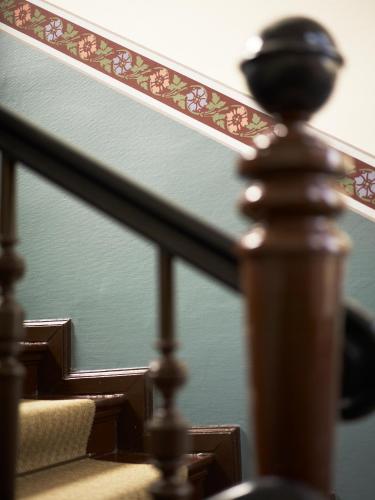 a close up of a wooden rail on a stair case at Hotel & Apartments Fürstenhof am Bauhaus in Weimar