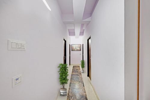 a hallway with two potted plants in a building at Hotel O Ethereal Inn in New Delhi