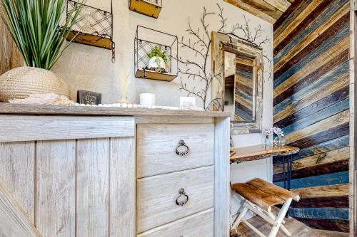 a bathroom with a wooden dresser and a mirror at The Montclair Drive Delight in Kalispell