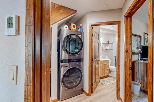 a bathroom with a washer and dryer in a house at Lost Trail 101 in Whitefish