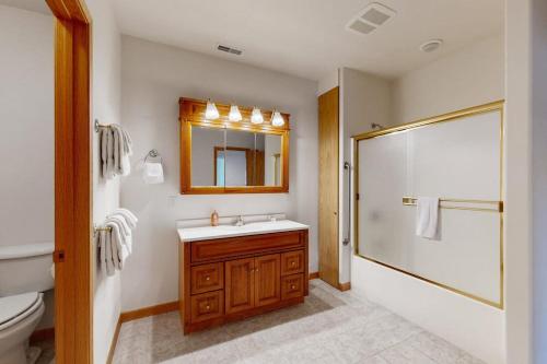 a bathroom with a toilet and a sink and a shower at Sunnyside Retreat in Kalispell