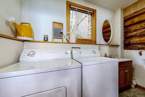 a white washer and dryer in a kitchen with a window at Pebbles & Sunshine in Lakeside