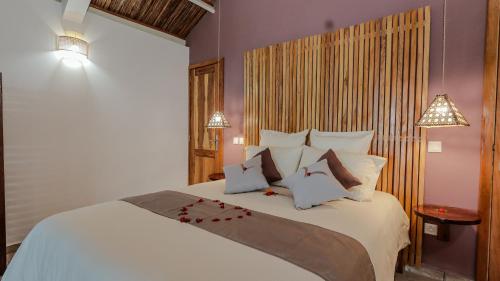 a bedroom with a large bed with white sheets and pillows at Maeva Beach in Sainte Marie