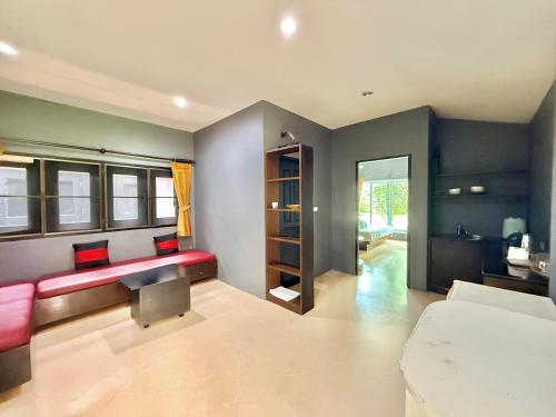 a living room with a red bench in a room at KT Garden Villa in Ko Samui
