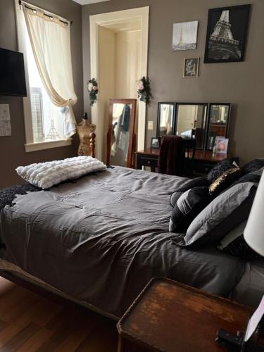 a large bed in a bedroom with a window at Graystone Manor in Albion