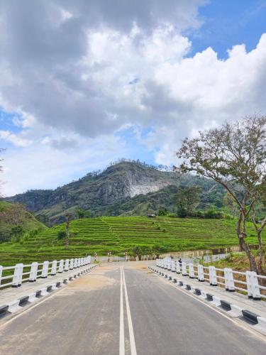 an empty road with a mountain in the background at Beyond ella in Ella