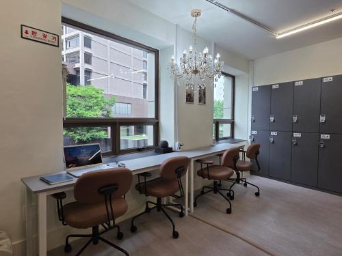 an office with a desk with a laptop and chairs at Solo Stay Myeongdong in Seoul