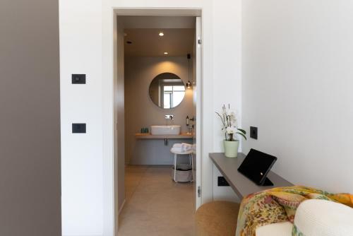 a bathroom with a sink and a desk in a room at Hotel Coste in Limone sul Garda